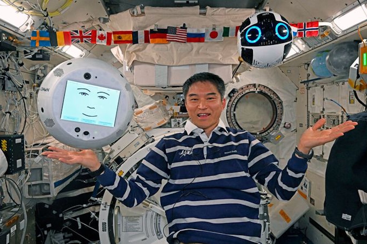 JAXA astronaut on the International Space Station with two CIMON robotic AI assistants